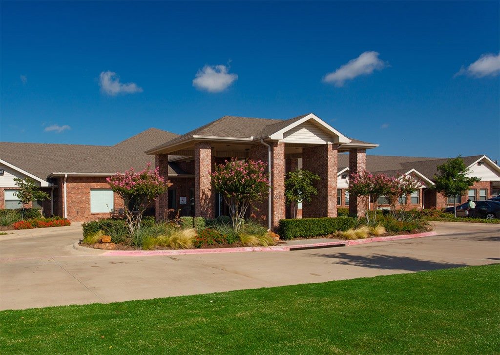 Town East Entrance with Brick exterior and covered entrance