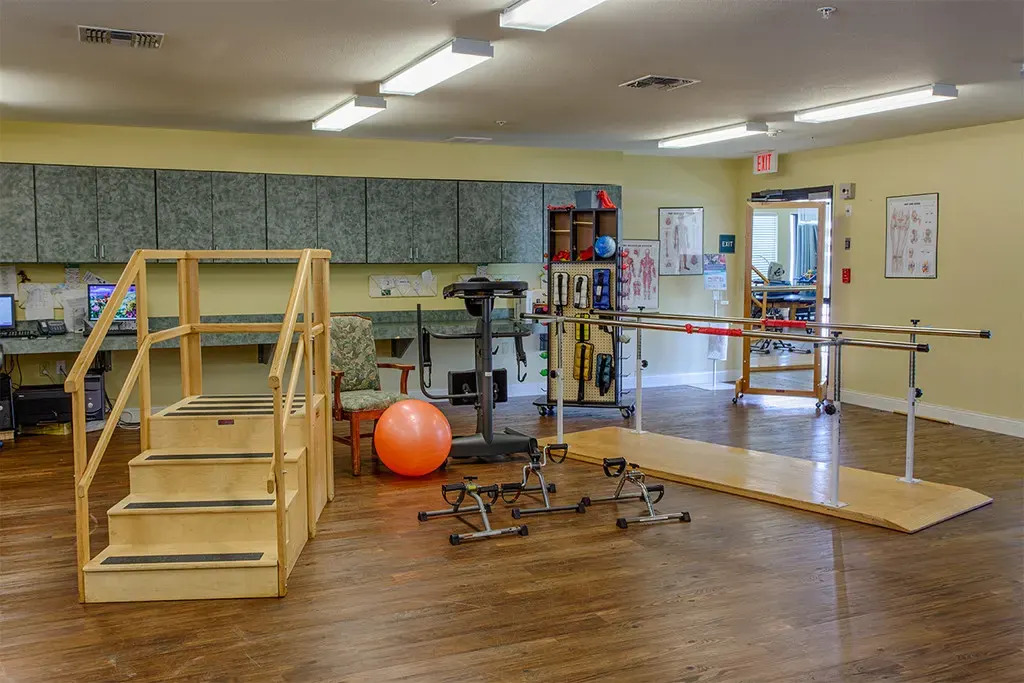 Image of one of two Town East Physical Therapy rooms with a wide variety of therapy tools