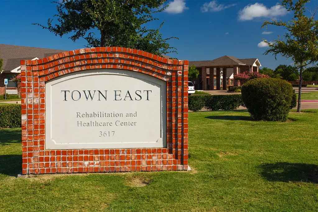 Brick welcome sign for Town East Rehabilitation & Care providing compassionate care in Mesquite, TX